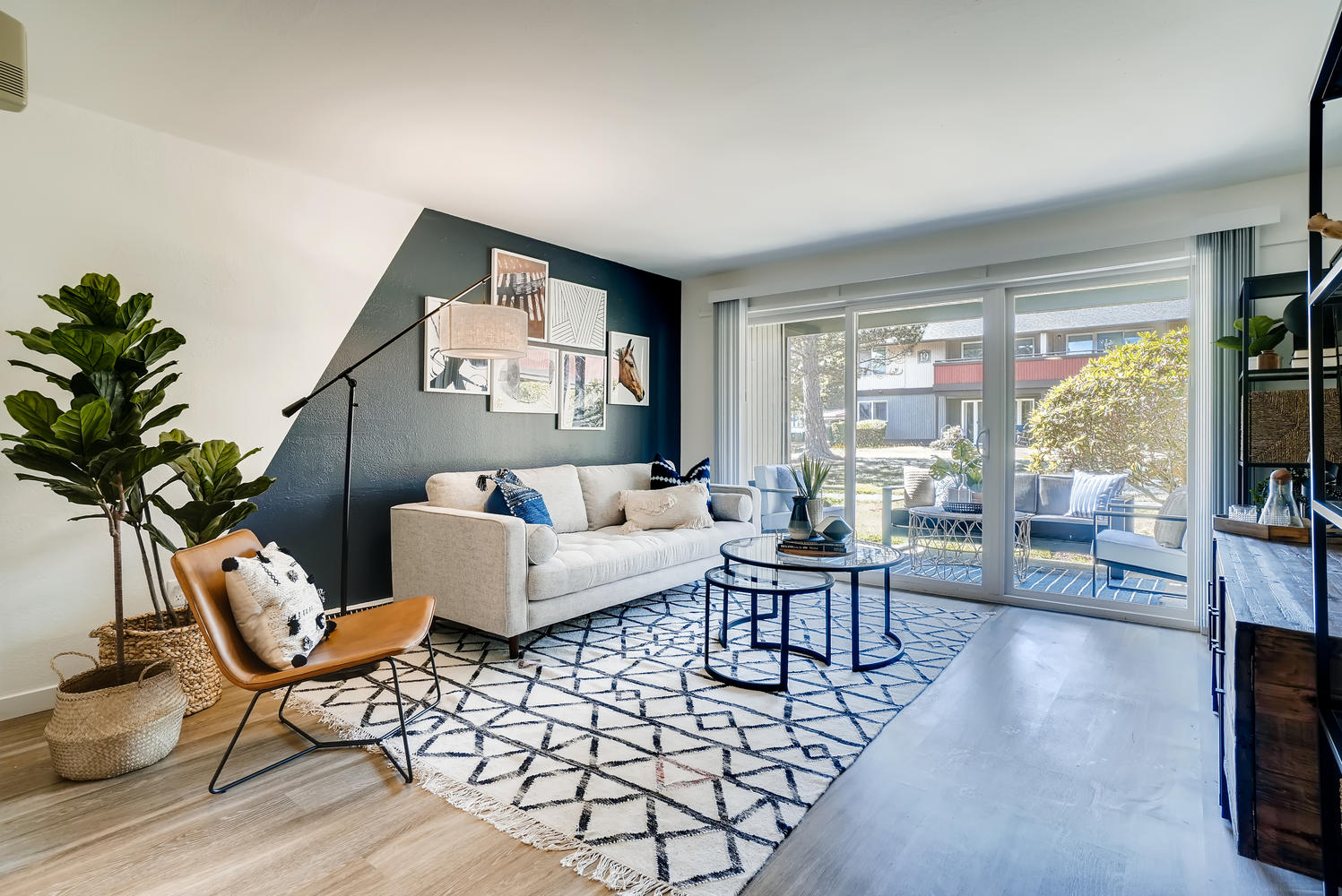 Living room with large windows and glass door to patio