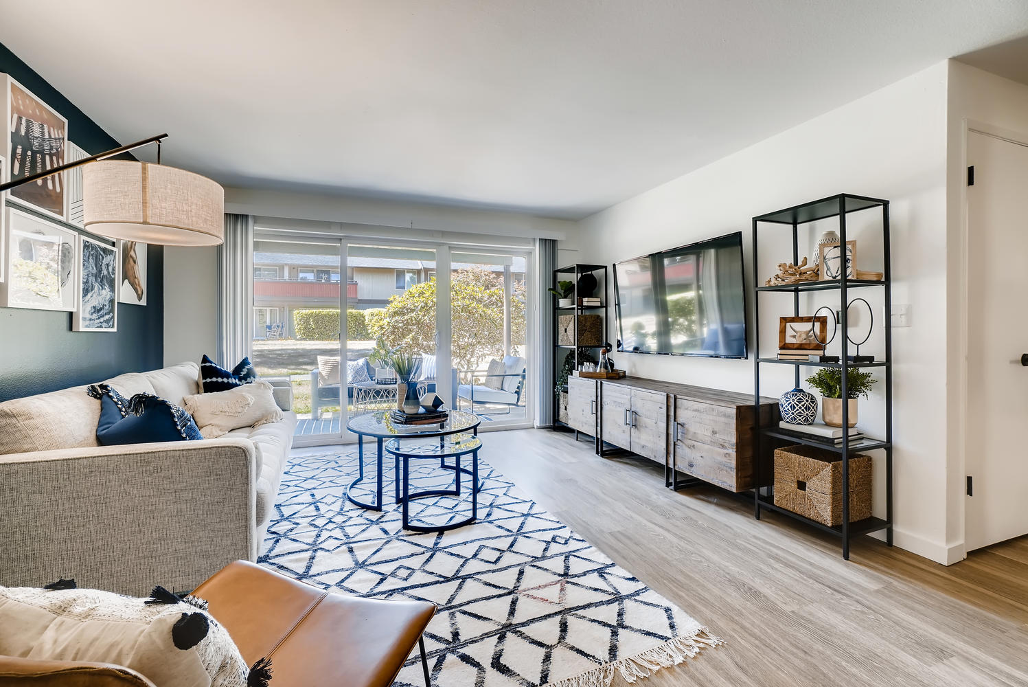 Living room with large windows and glass door to patio