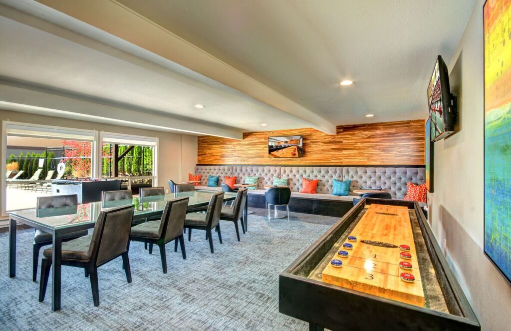 Clubhouse lounge with tables, booths, and games