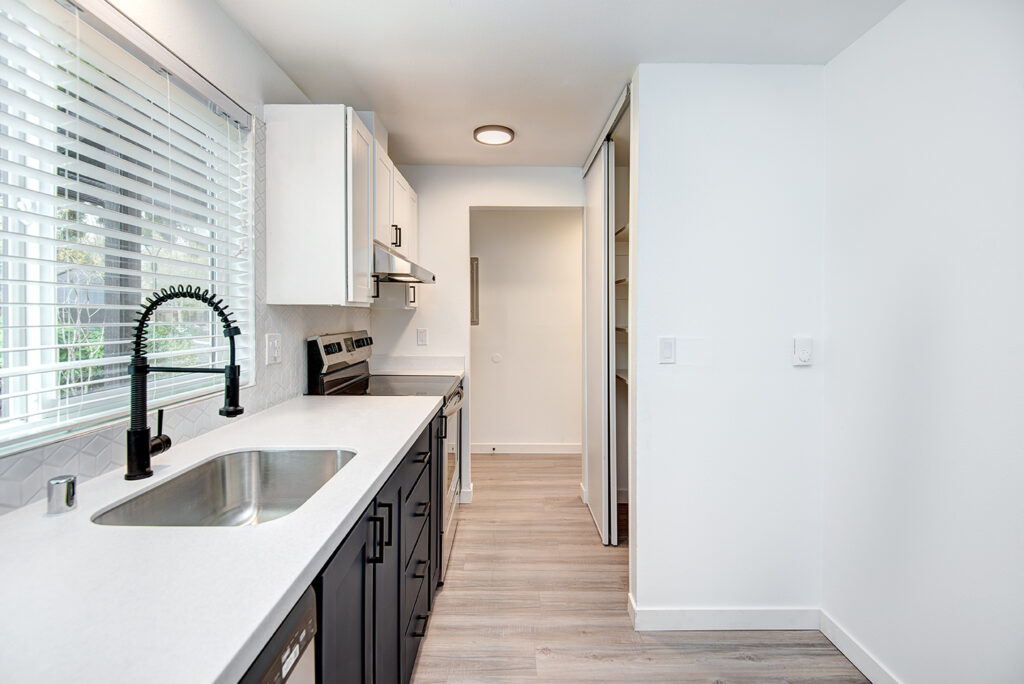 Kitchen with white countertops and a window