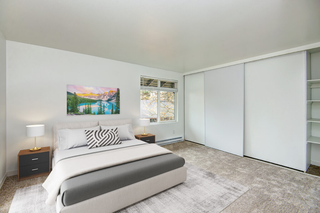 carpeted bedroom with sliding closet doors and built in shelves
