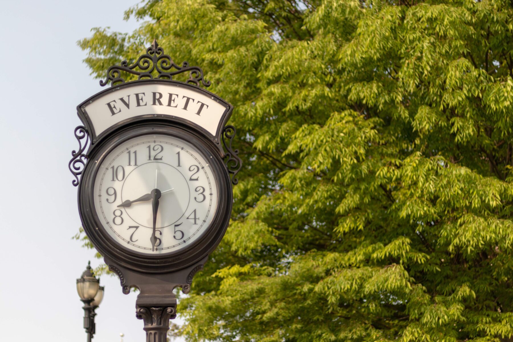 Outdoor sign with a clock on it